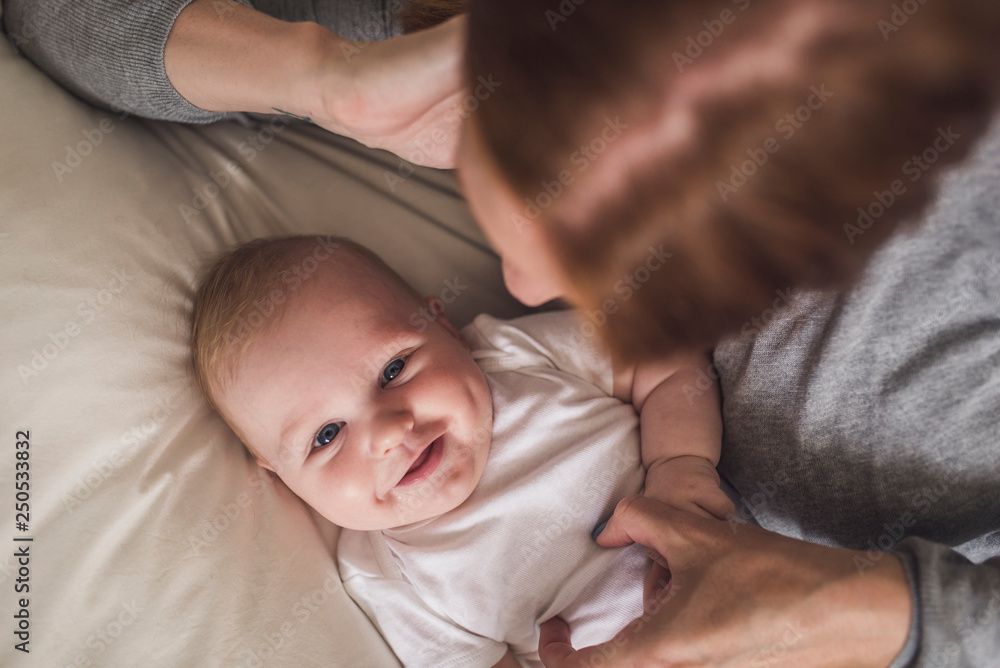 Overhead view of mother with son relaxing on bed at home Overhead view of mother with son relaxing on bed at home