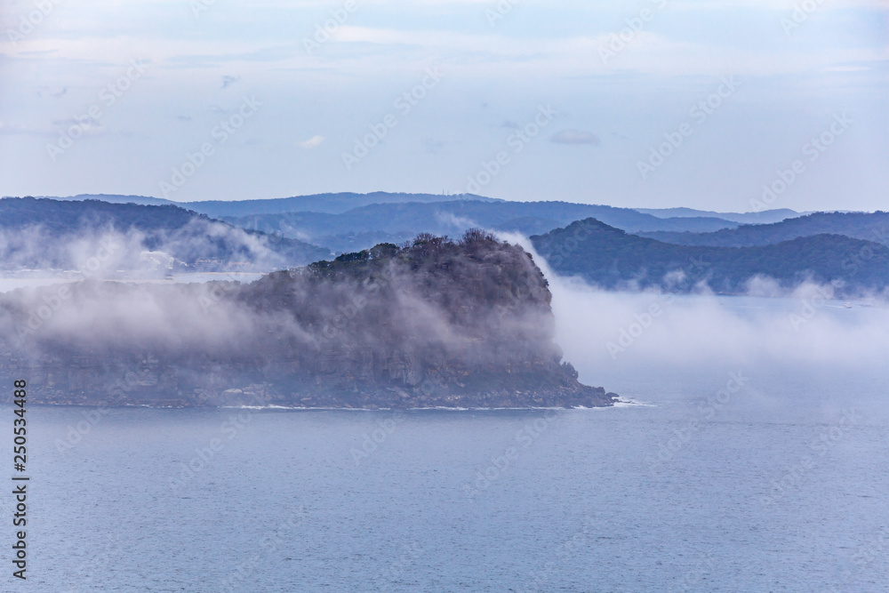 Lion Island under low clouds at Broken Bay. Sydney, New South Wales, Australia