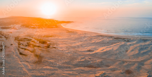 Fototapeta Naklejka Na Ścianę i Meble -  Aerial panorama of sunrise over ocean coastline with copy space
