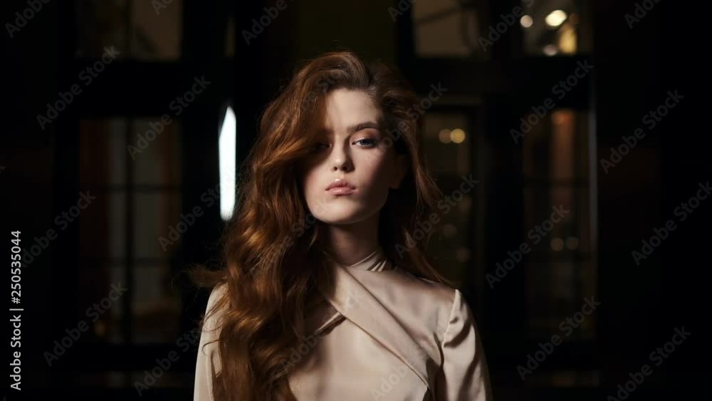 Portrait Of An Elegant Girl In A Stylish Dress On A Dark Background. Portrait Of An Elegant Girl In A Stylish Dress On A Dark Background.