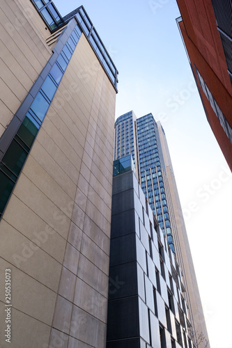 architecture, building, buildings, business, city, day, exterior, from below, high, imposing, large, looking up, looming, low angle, office, outside, sky, skyline, skyscraper, tall, tall building, tow