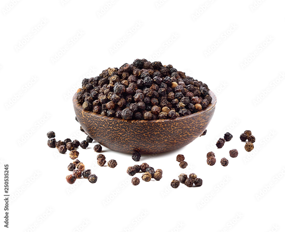 Black peppercorn in wood bowl isolated on white background Black peppercorn in wood bowl isolated on white background