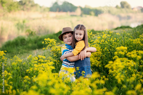 happy cute children, brother and sister, boy and girl on the nature in the park hug, true friendship © Юлия Призова
