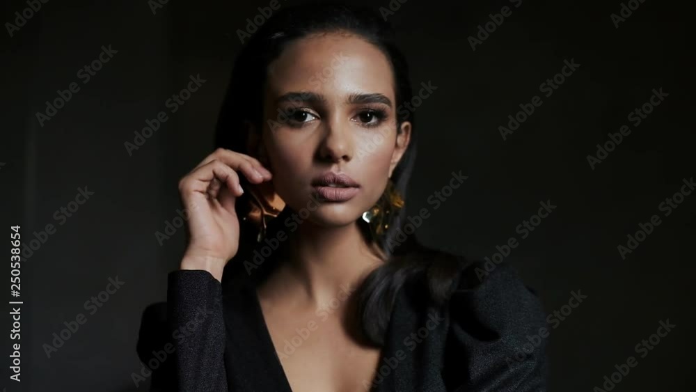Portrait Of A Gentle Girl In A Stylish Blouse On A Black Background. Close up. Portrait Of A Gentle Girl In A Stylish Blouse On A Black Background. Close up.