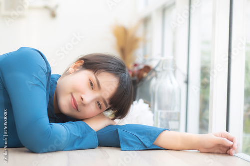Beautiful portrait young asian woman smiling sitting lying at cafe, model girl happy with relax and resting looking camera, lifestyle concept.