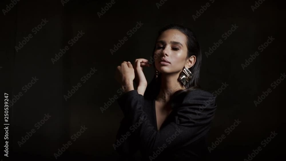 Portrait Of A Gentle Girl In A Stylish Blouse On A Black Background. Close up. Portrait Of A Gentle Girl In A Stylish Blouse On A Black Background. Close up.