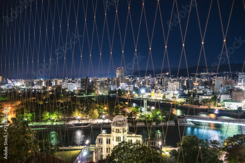 View from Orizuru Tower of Hiroshima Cityscape at night on the side of Motoyasu River in Japan with the Atomic Bomb Dome in the foreground and the Peace Memorial Park behind. photo