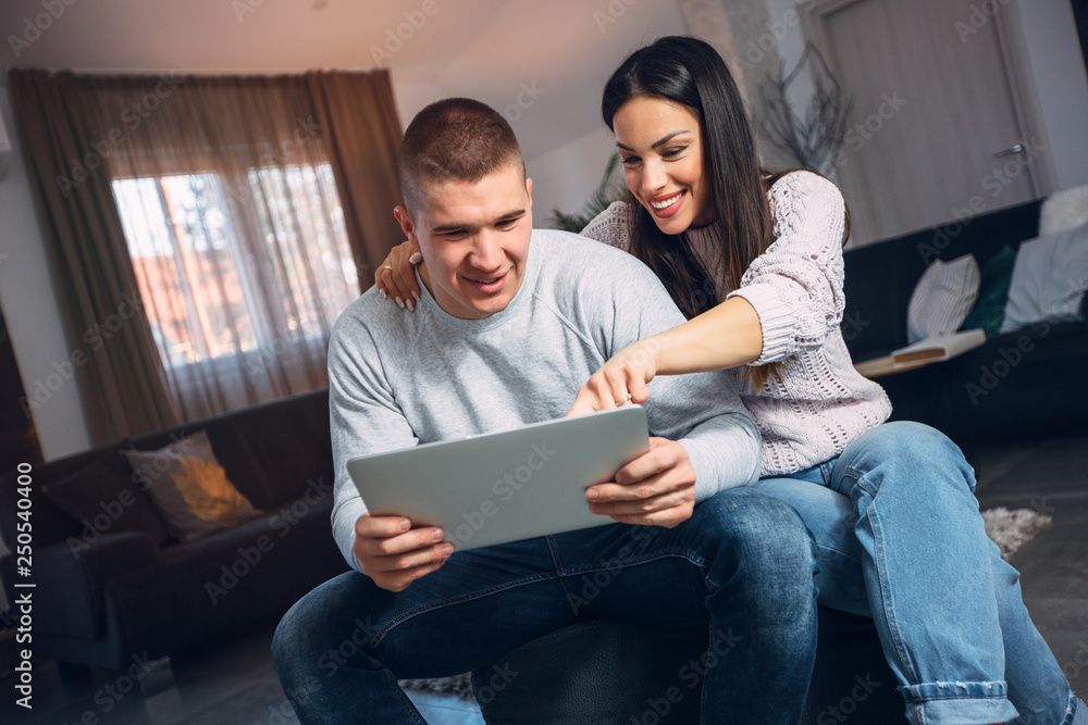 beautiful woman and handsome man using an ipad beautiful woman and handsome man using an ipad