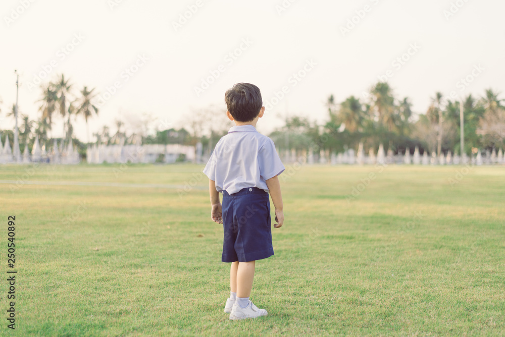 Outdoor portrait of a Lonely Asian student kid in school uniform standing. Outdoor portrait of a Lonely Asian student kid in school uniform standing.