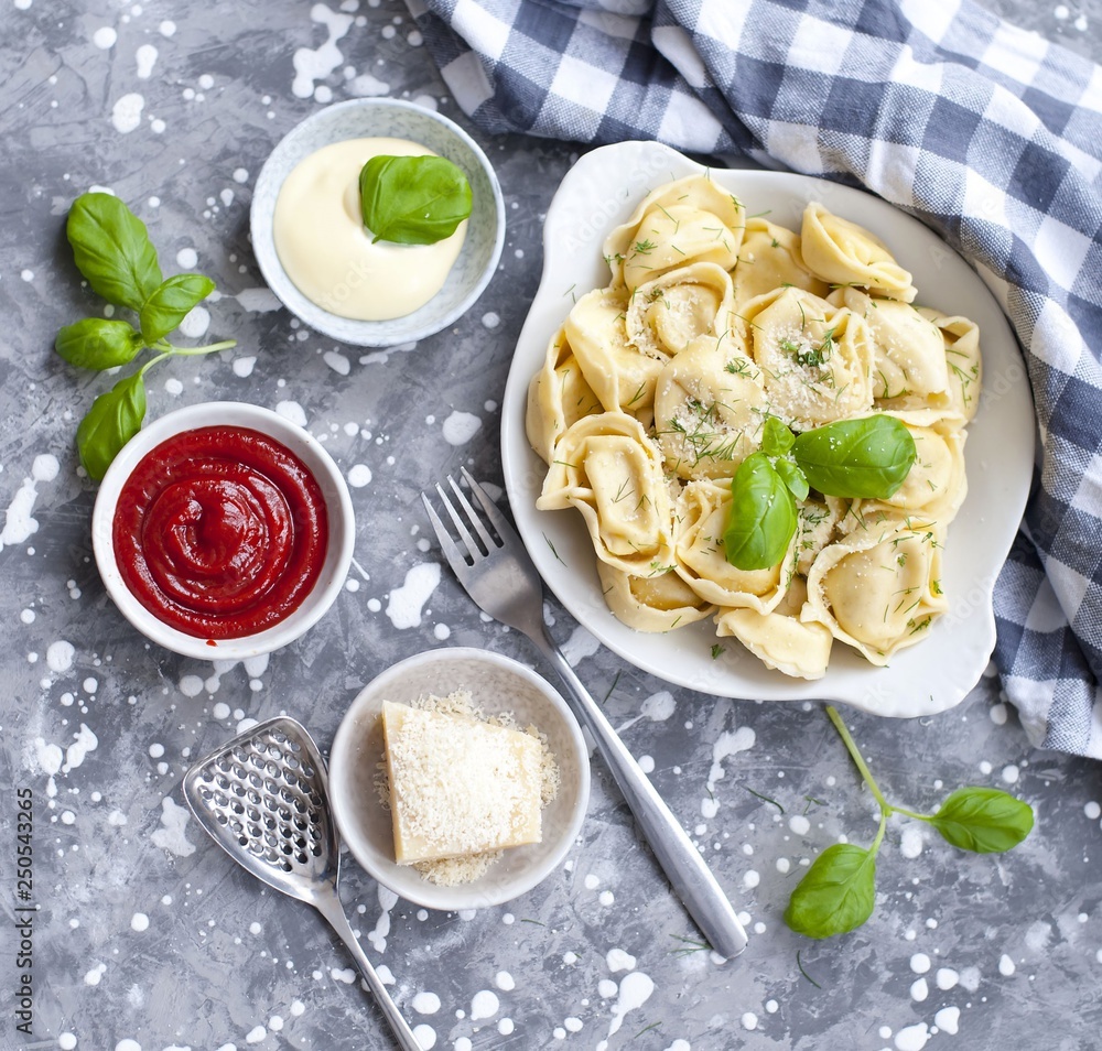 fresh tortellini in a bowl with basil and parmesan fresh tortellini in a bowl with basil and parmesan