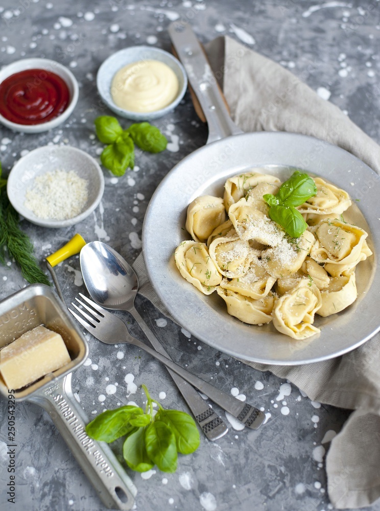fresh tortellini in a bowl with basil and parmesan fresh tortellini in a bowl with basil and parmesan