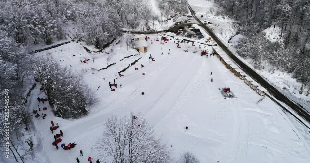 Aerial view: Tubing one of the most popular types of winter recreation. 4k Aerial view: Tubing one of the most popular types of winter recreation. 4k