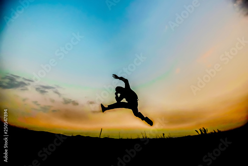 Wallpaper Mural silhouettes; a man jumping in the sky Torontodigital.ca