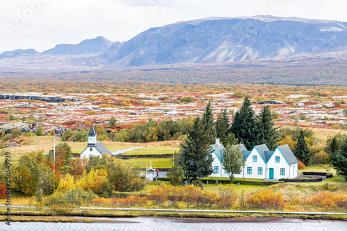 Thingvellir National Park with colorful yellow orange autumn foliage during day in Iceland Golden circle and farmhouse church called Thingvalla Kirkja high angle view photo