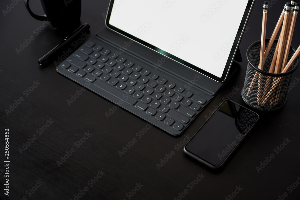Business Items tablet, pen, mobile phone on dark wood workspace table and copy space Business Items tablet, pen, mobile phone on dark wood workspace table and copy space
