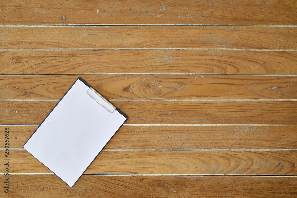 Clipboard with white sheet on wooden background Clipboard with white sheet on wooden background