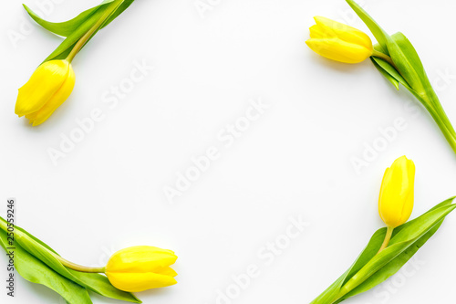 Spring composition. Bouquet yellow tulips on white background top view copy space frame