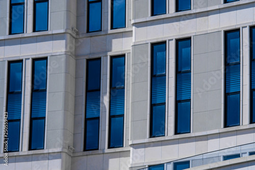 Part of modern office building with blue windows closeup. European architecture example
