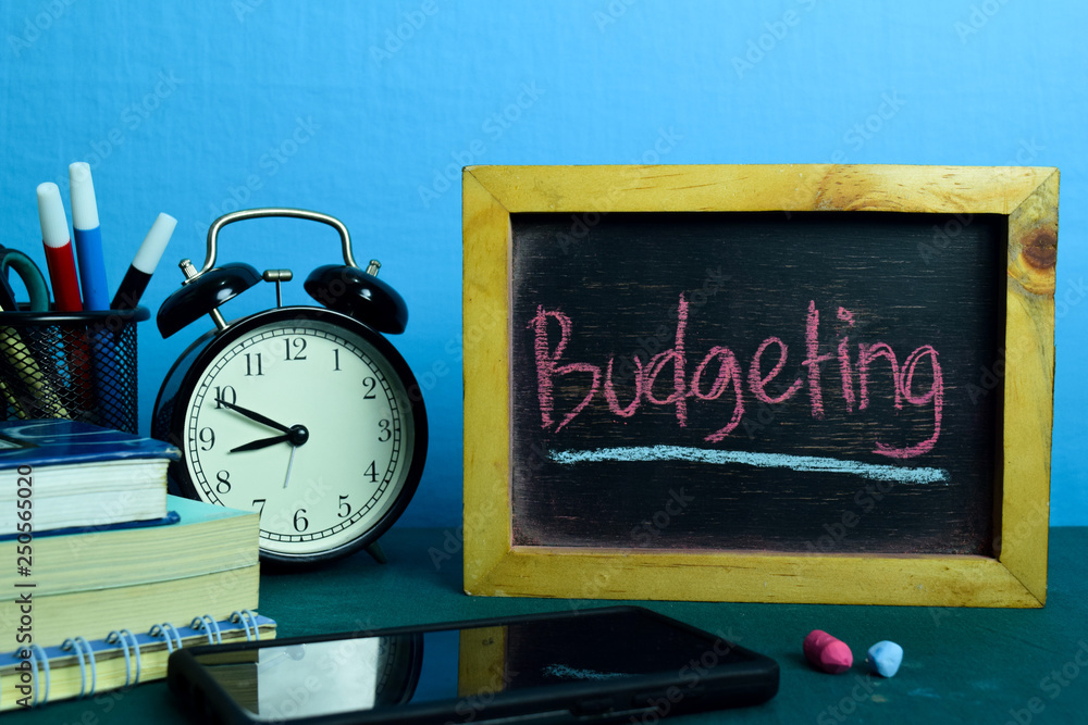 Budgeting Planning on Background of Working Table with Office Supplies. Business Concept Planning on Blue Background Budgeting Planning on Background of Working Table with Office Supplies. Business Concept Planning on Blue Background