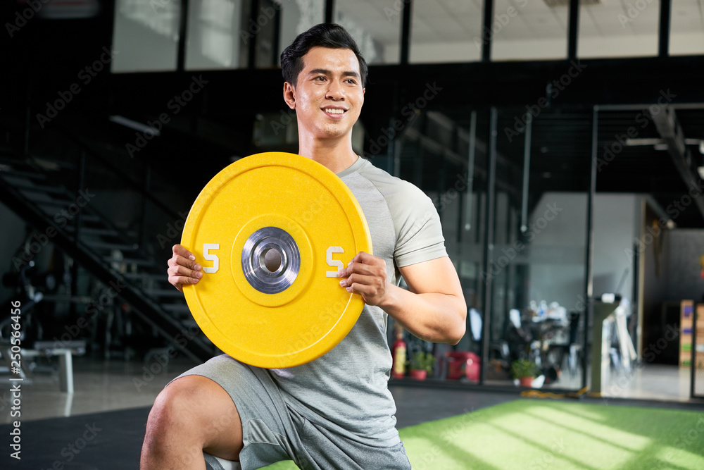 Young man enjoying training with weights Young man enjoying training with weights