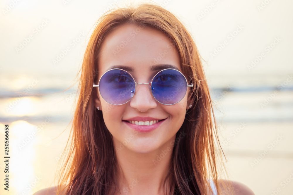 Close up shot of good looking female tourist enjoys free time outdoor near ocean beach, looks at camera during leisure on sunny summer day making selfie. Happy smiling tourist in tropics air kiss Close up shot of good looking female tourist enjoys free time outdoor near ocean beach, looks at camera during leisure on sunny summer day making selfie. Happy smiling tourist in tropics air kiss
