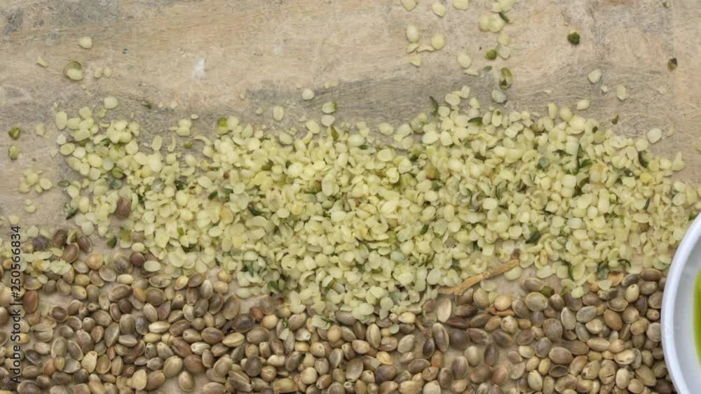 hemp seed, hearts and oil against textured bark paper, top view pan hemp seed, hearts and oil against textured bark paper, top view pan