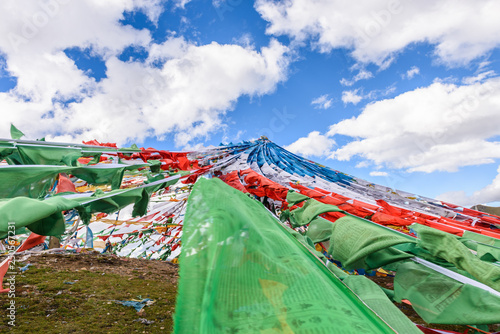 Colorful prayer flags at the Mila Mountain Pass (between the Lhasa Prefecture and the Nyingchi Prefecture) at the altitude of 5200m ,Tibet, China. photo