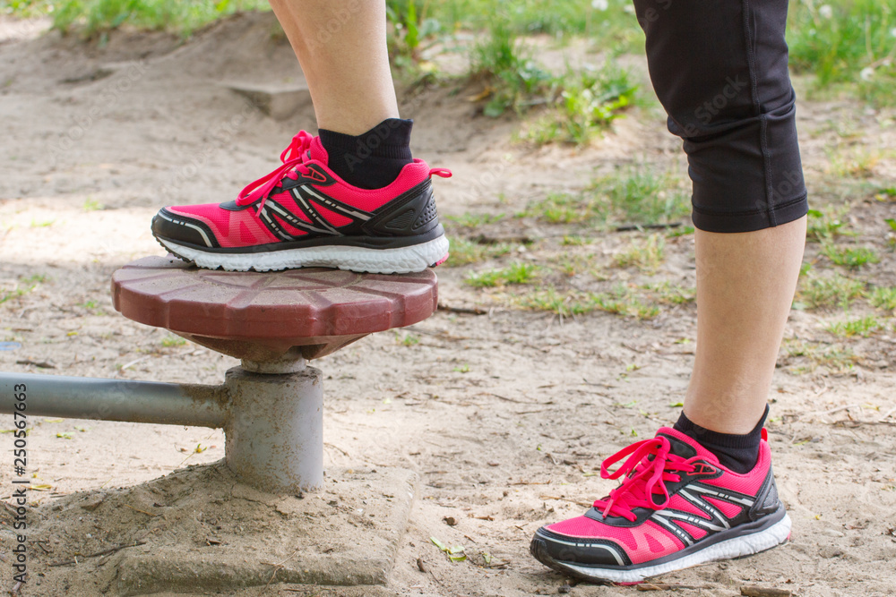 Legs of elderly senior woman on outdoor gym, healthy lifestyle concept