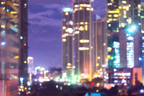 Unfocused shot with room for copyspace showing highrise buildings in a modern city with electricity lighting the highways and buildings, amid good night life and cityscape.
