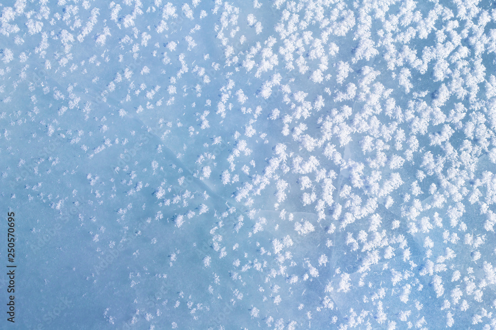 Blue ice with snowflakes on the surface. Winter texture. Blue ice with snowflakes on the surface. Winter texture.