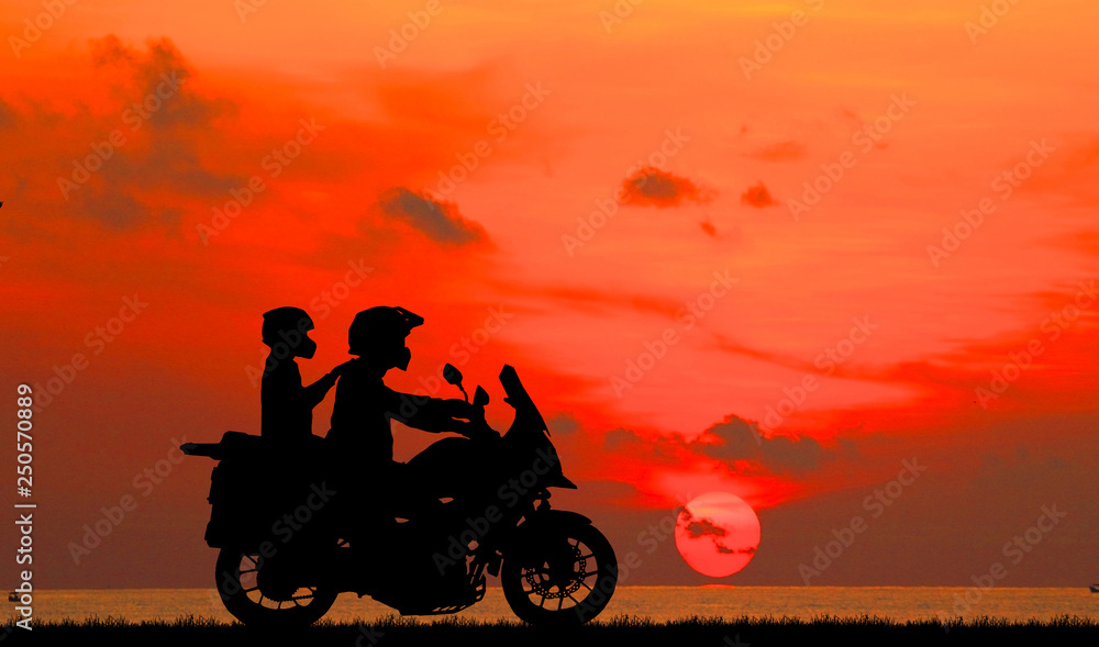 couple on motorcycle sunset