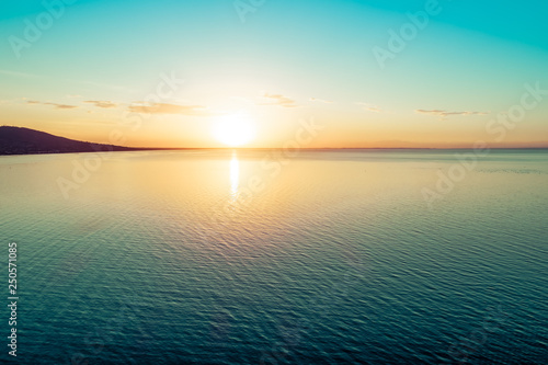 Sunset over water - aerial view with copy space