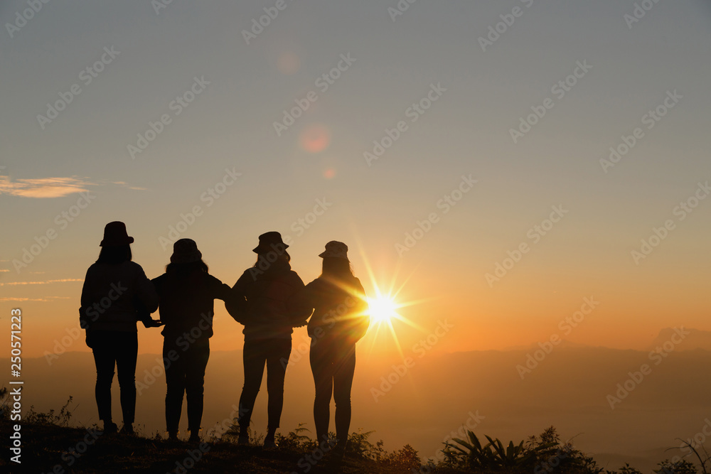 Group of happy people playing at summer sunrise in nature