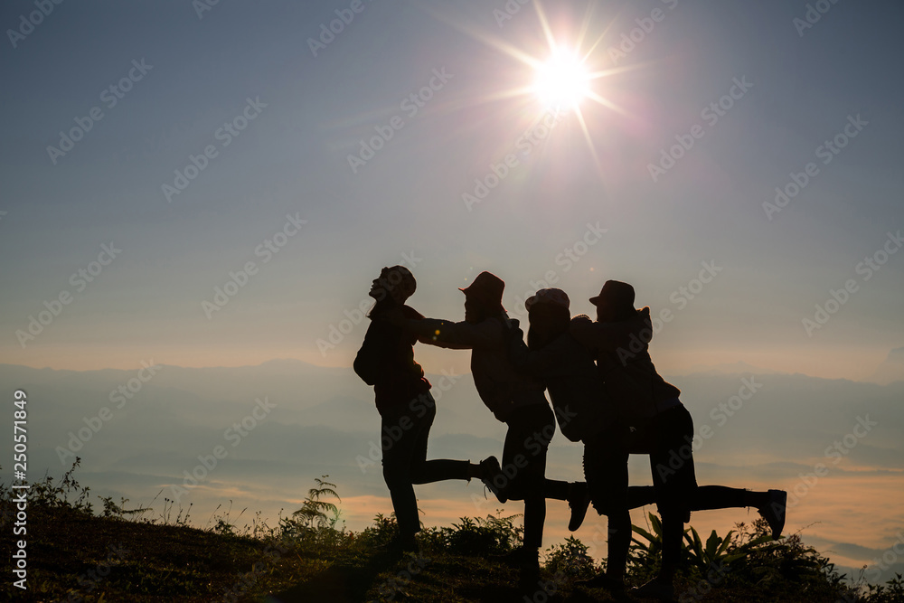 Group of happy people playing at summer sunrise in nature.
