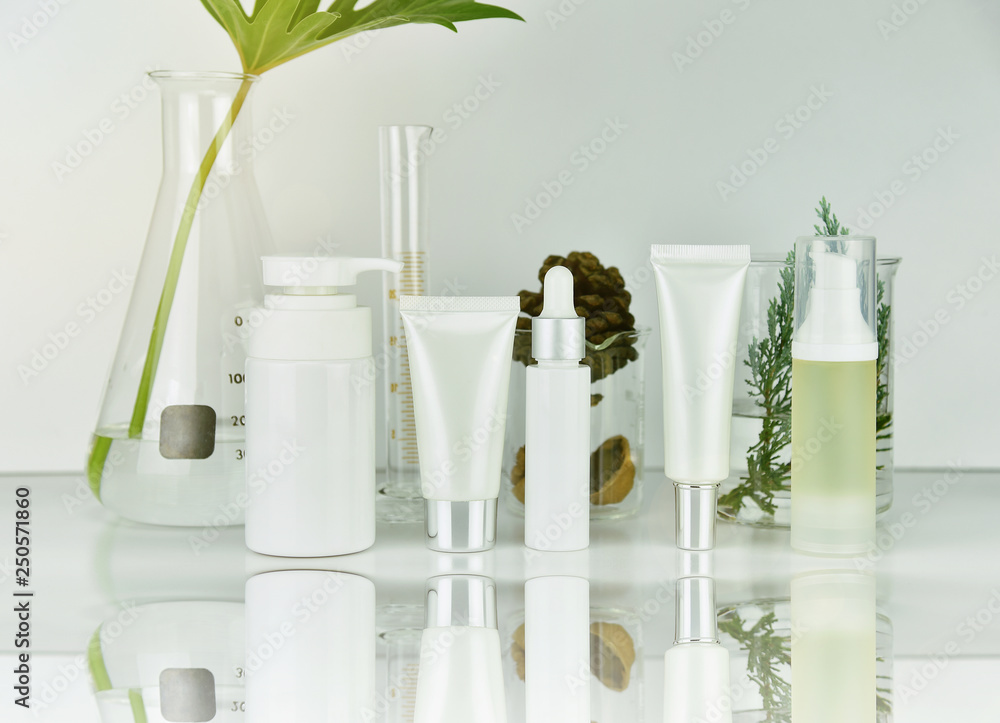 Cosmetic and skincare bottle containers with green herbal leaves, Blank label package for branding mock-up, Natural organic beauty product research and development concept.