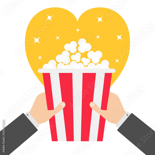 Two human businessman hands holding popcorn box. Heart shape. I love Movie Cinema icon in flat design style. Pop corn. Yellow background. Shining stars.