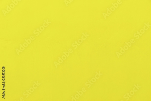 Abstract background from yellow concrete wall. Free space for text.