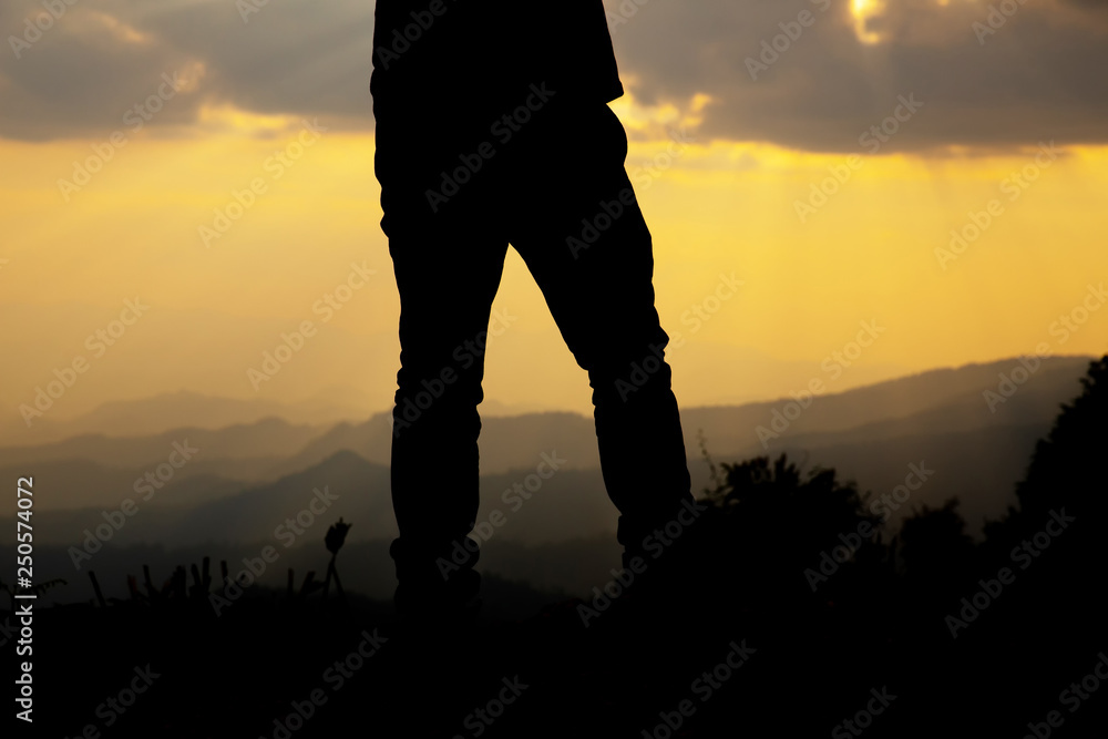 relax man on hill at sunset silhouette.