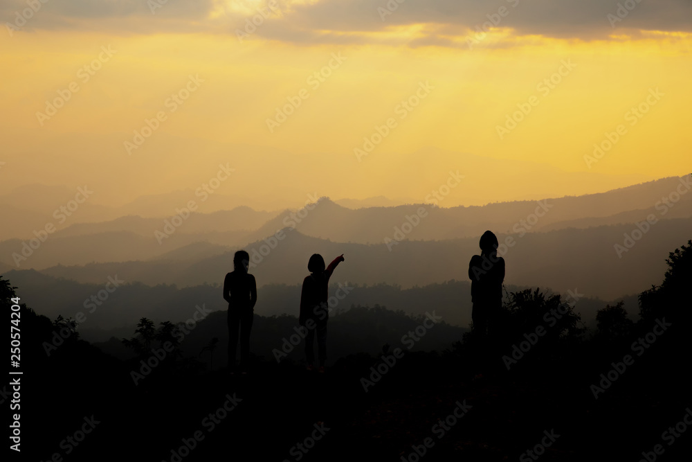 Group of happy people playing at summer sunset in nature