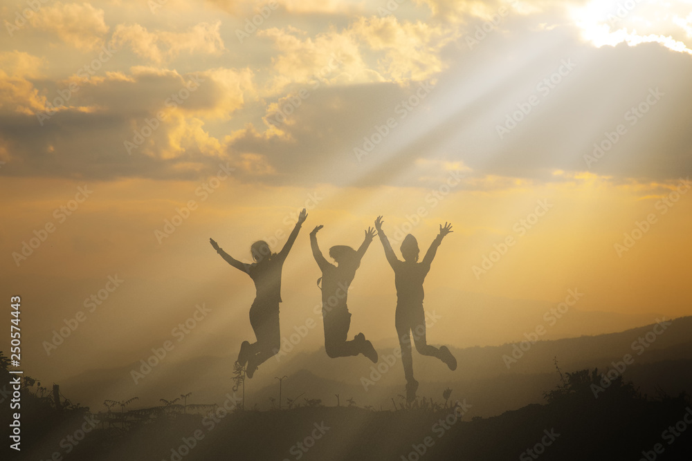 Group of happy people playing at summer sunset in nature