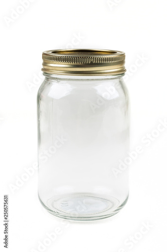 Empty glass canning jar over a white background