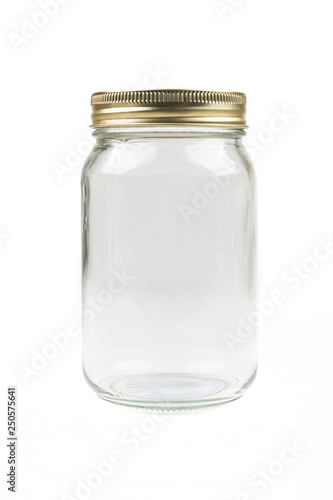 Empty glass canning jar over a white background