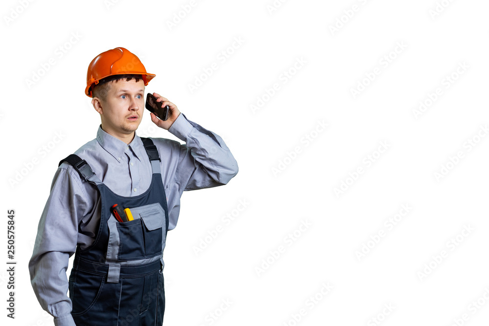Builder worker receives instructions over the phone. Repair and construction did not go according to plan. isolated Builder worker receives instructions over the phone. Repair and construction did not go according to plan. isolated