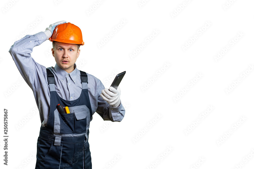 The engineer has a big problem. By phone they reported incorrect information on construction. A worker at a construction site holds his hand on his head and does not know how to make repairs. isolated The engineer has a big problem. By phone they reported incorrect information on construction. A worker at a construction site holds his hand on his head and does not know how to make repairs. isolated