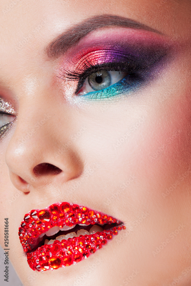 Bright eye makeup red lips in rhinestones. Pink and blue color, colored eyeshadow. Stock Photo | Adobe Stock