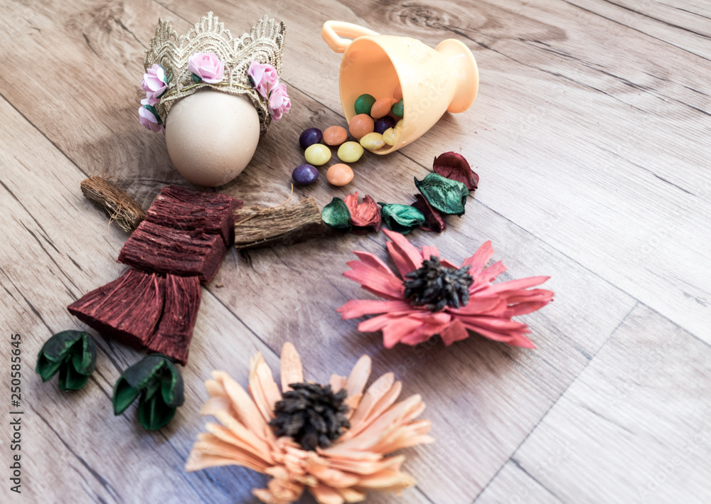 Fototapeta Easter, preparation for Easter, still life, story for Easter, eggs, colored objects, flowers, wooden background, wreath,