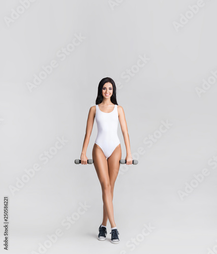 Slender and young girl with beautiful and fit body. Woman in swimsuit. Sport, diet, health and beauty concept.