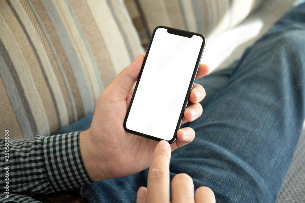 male hands holding phone with isolated screen on the sofa