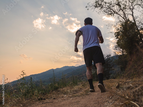 Silhouette of young man running during sunset