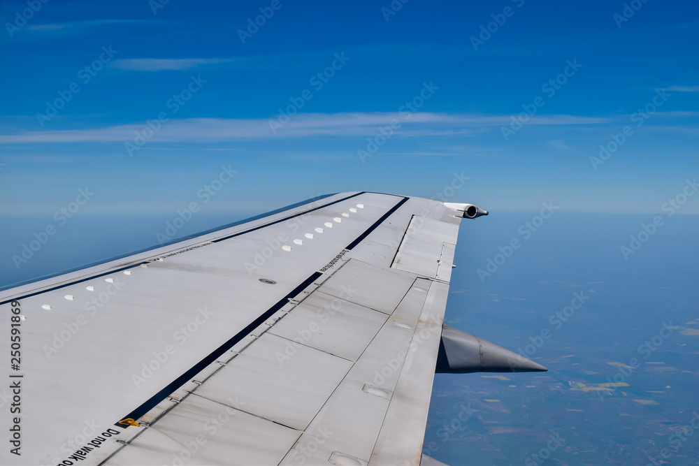 The right wing of a plane through the clear sky The right wing of a plane through the clear sky
